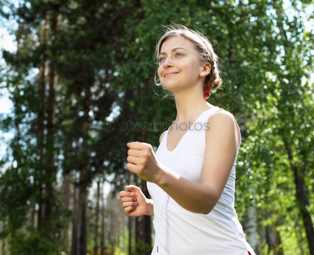 Similar – Woman jogging along a country road while listening to music