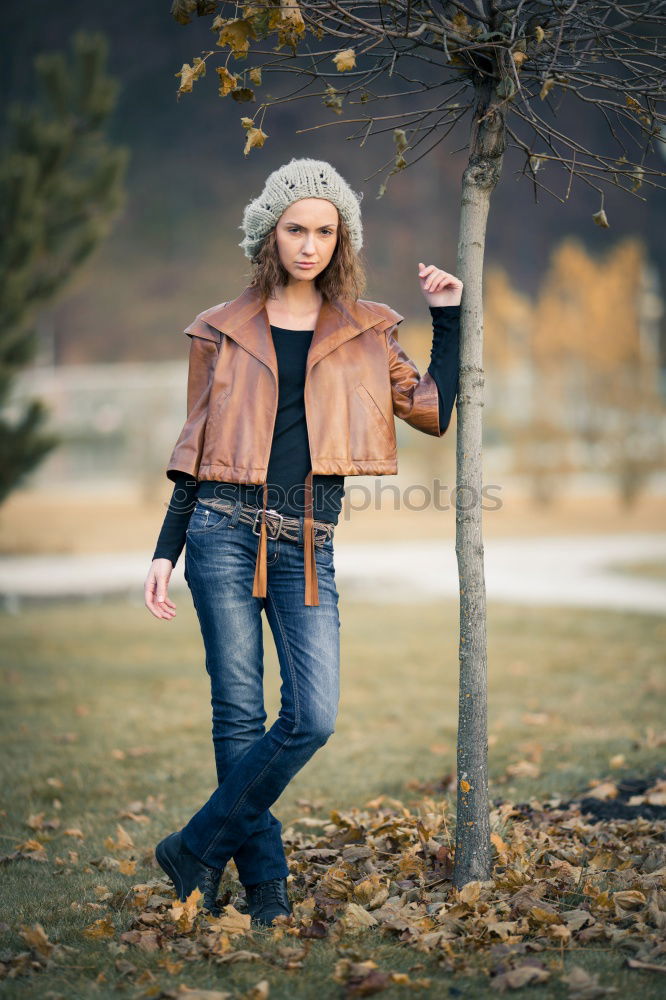 Similar – Woman in Winter Outfit in Front Old Gray Wall