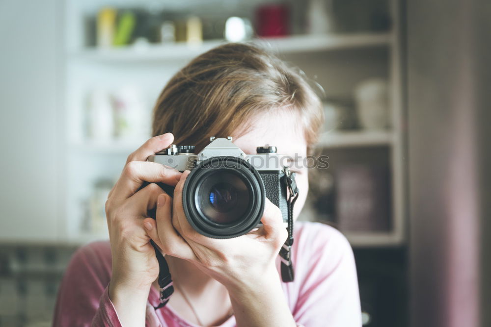 Similar – Young redhead woman taking shots with her analog camera