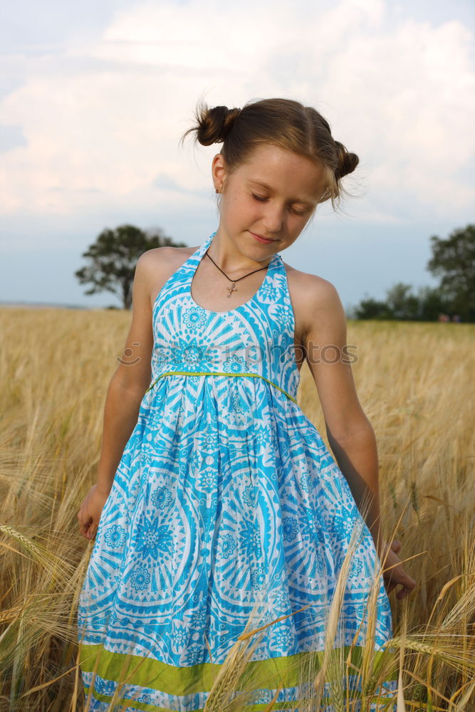 Similar – Image, Stock Photo Portrait of a young, tattooed woman sitting barefoot in a summer dress in a field