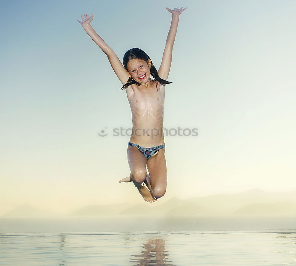 Similar – Playful girl standing in pier near lake