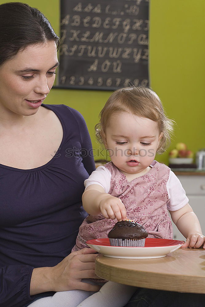 Similar – Woman feeding her little girl in kitchen