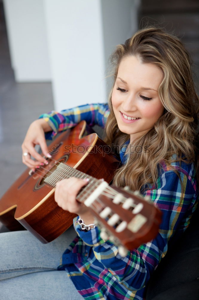 Similar – Pensive woman sitting near guitar on floor