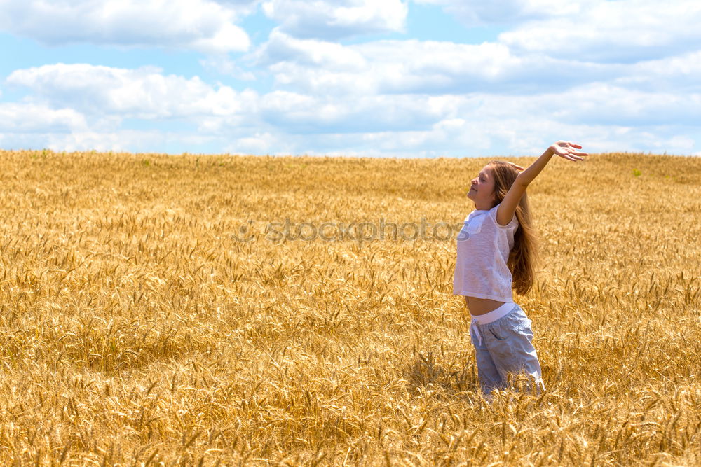 Similar – Young cowgirl in a field of cereals