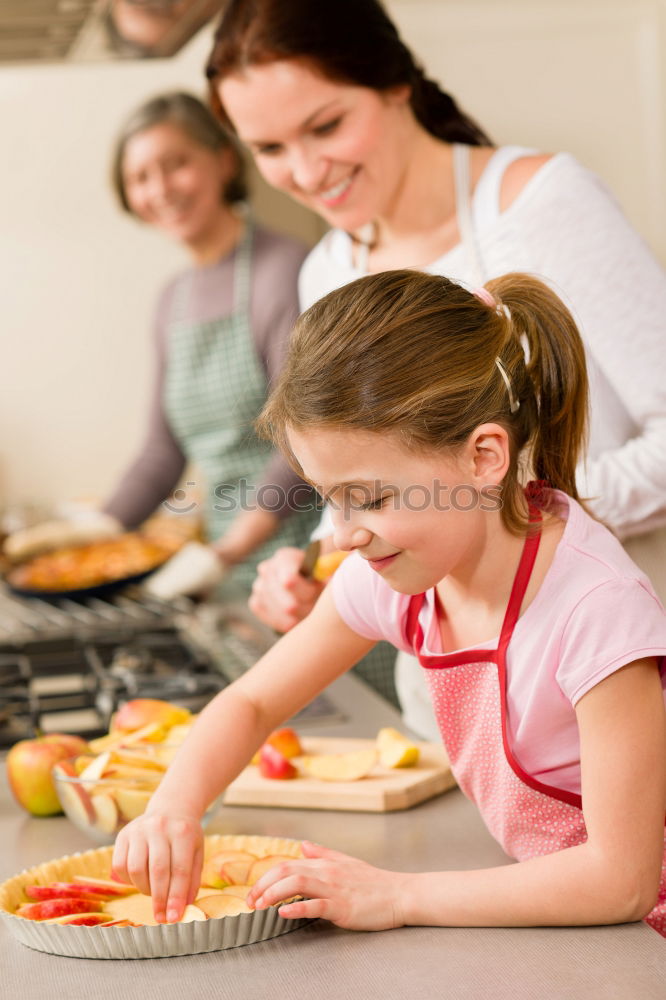 Similar – Image, Stock Photo Little sisters cooking with her mother in the kitchen.
