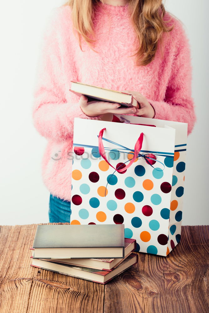 Image, Stock Photo Young girl turning the pages of book in bookstore