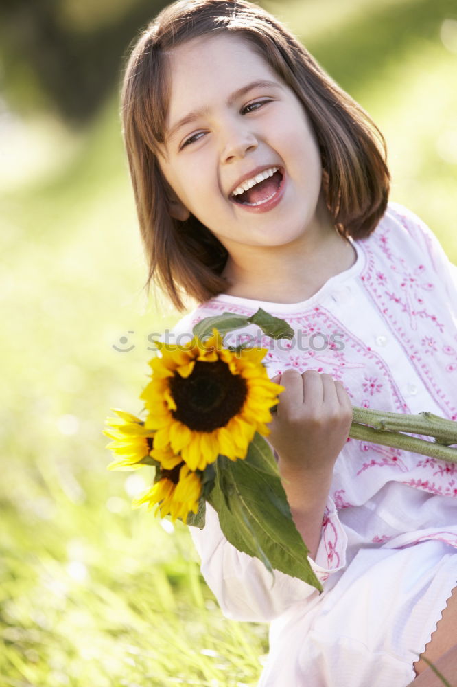 Similar – romantic portrait of happy child girl picking bouquet of beautiful blue delphinium flowers from summer garden