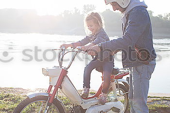 Similar – Father and daughter playing on the road at the day time.