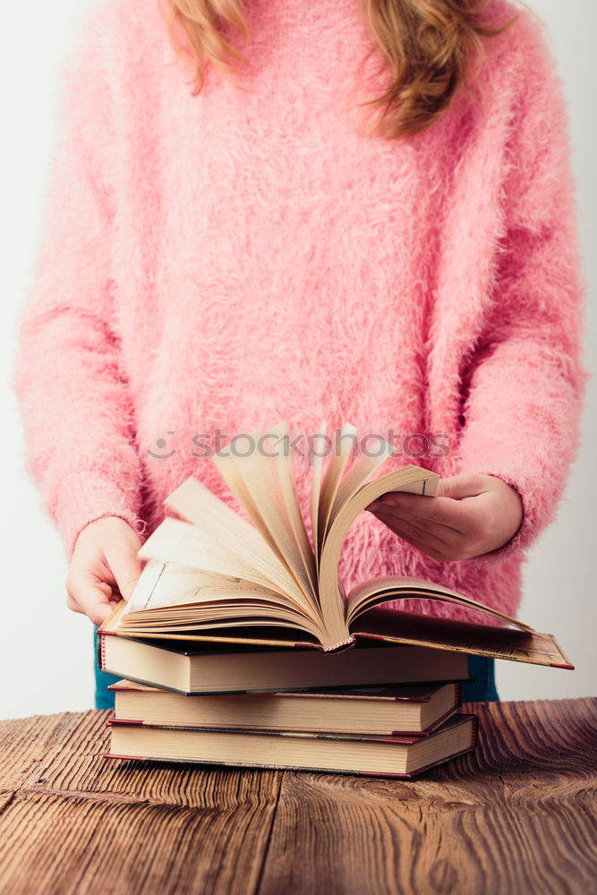 Similar – Image, Stock Photo Young girl turning the pages of book in bookstore