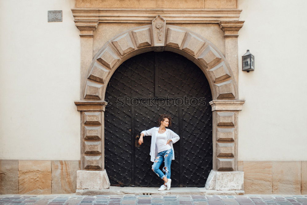 Image, Stock Photo young man waits at a wooden door and supports himself