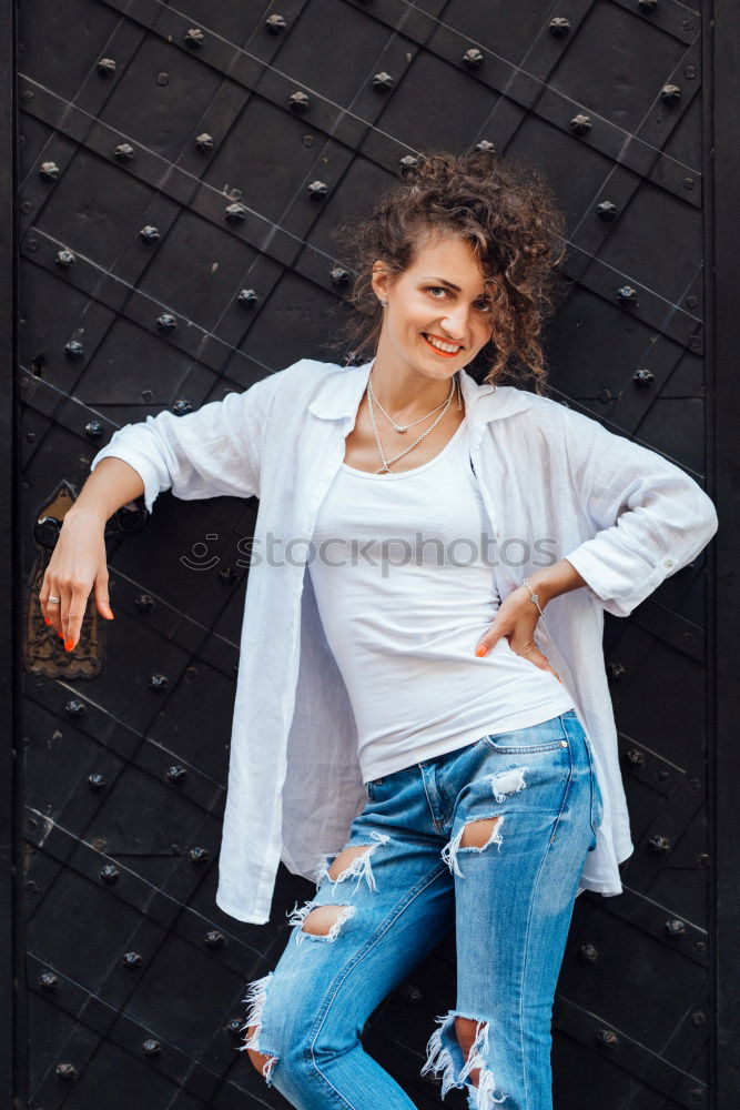 Smiling young arabic woman with black curly hairstyle