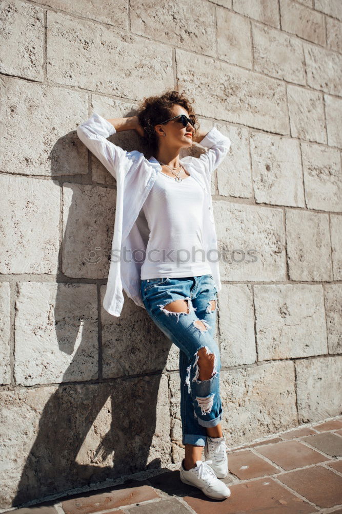 Similar – two women friends sitting down at stairs outdoors using laptop