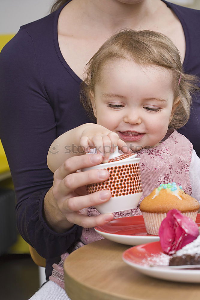 Similar – Woman feeding her little girl in kitchen