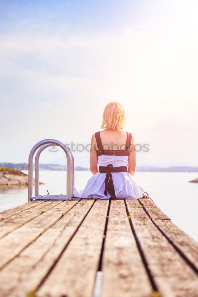 Similar – Mother and her daughter sitting on a bench on wintery day