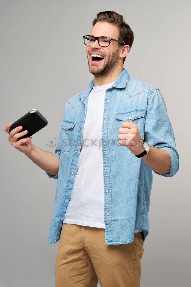Similar – Image, Stock Photo Young smiling man looking at his smartphone in the street