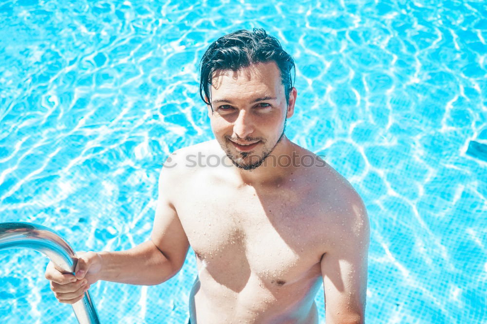 Similar – Young handsome man posing near a pool