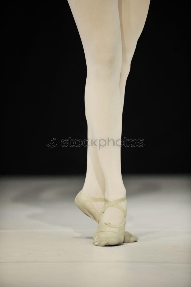 Similar – Ballerina laces up her pointe shoes