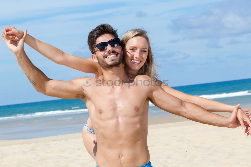 Similar – Close-up of young adult’s muscular bodies on the beach