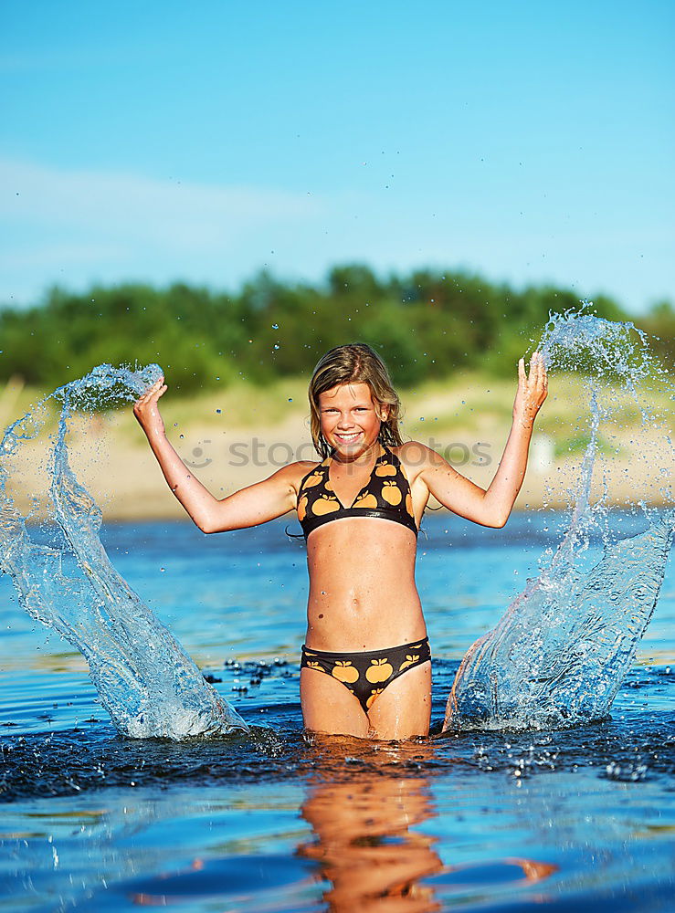 Similar – Playful girl standing in pier near lake