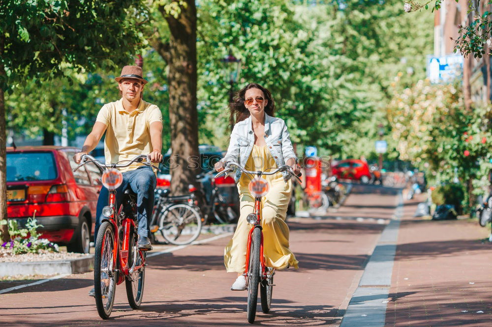 Similar – Happy family with a child riding bicycles by the city