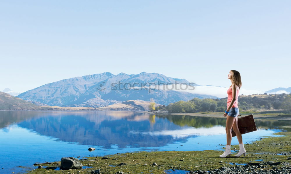 Similar – Woman sitting on stone at lake