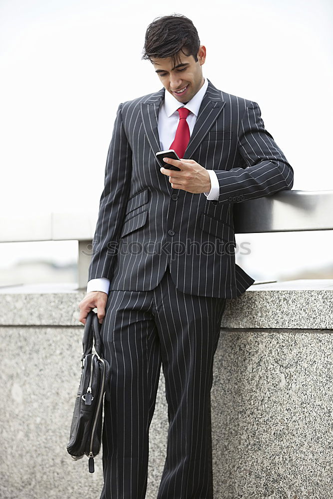 Similar – Image, Stock Photo Elegant Young Businessman in the Street Using a Mobile Phone