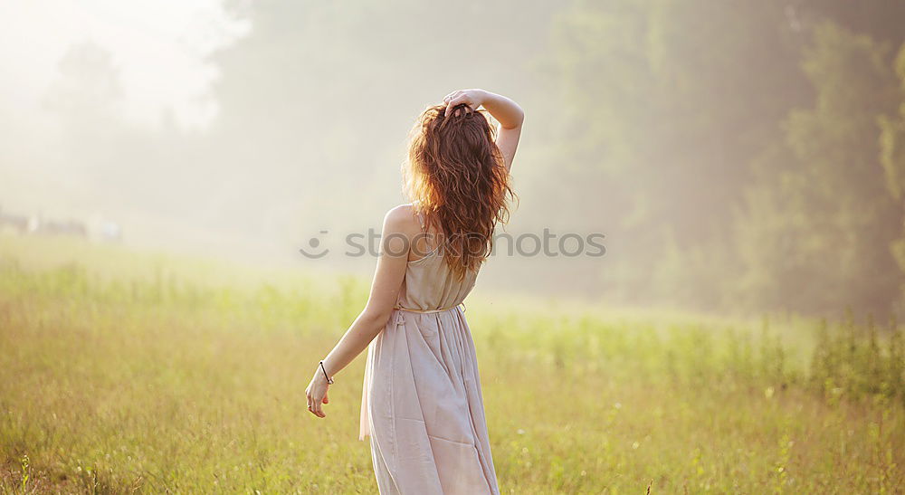 Similar – Young woman enjoying the sunset with wind blowing her hair