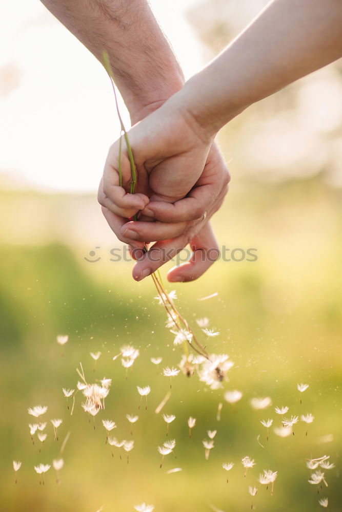 Hand in hand with a bouquet of flowers