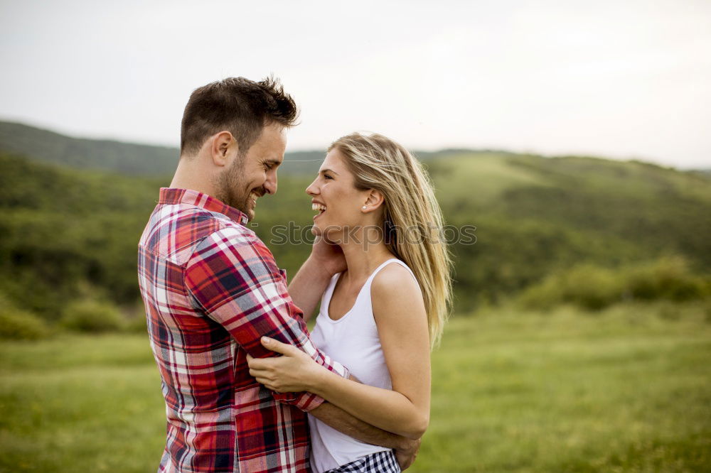 Similar – Image, Stock Photo Young loving couple hugging in the street.