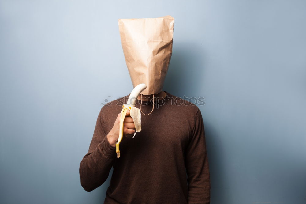 Similar – Person with paper bag on head pointing at camera