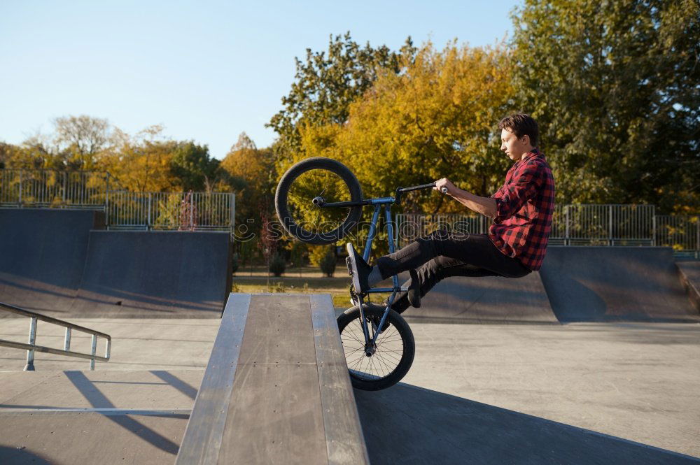 Similar – Girl on BMX bike in the air in halfpipe