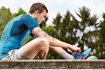 Similar – Sporty man sitting with towel and water bottle in gym floor