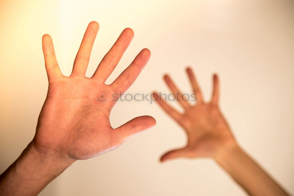 Similar – Image, Stock Photo Forearm and hand with spread fingers against a yellow background