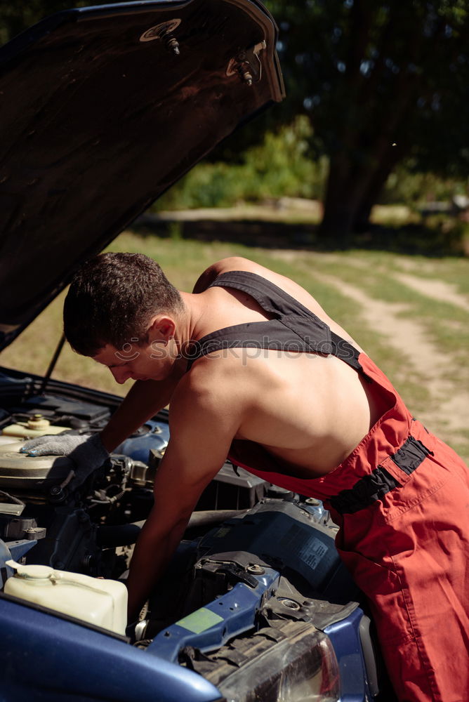 Similar – young guy repairing an old car