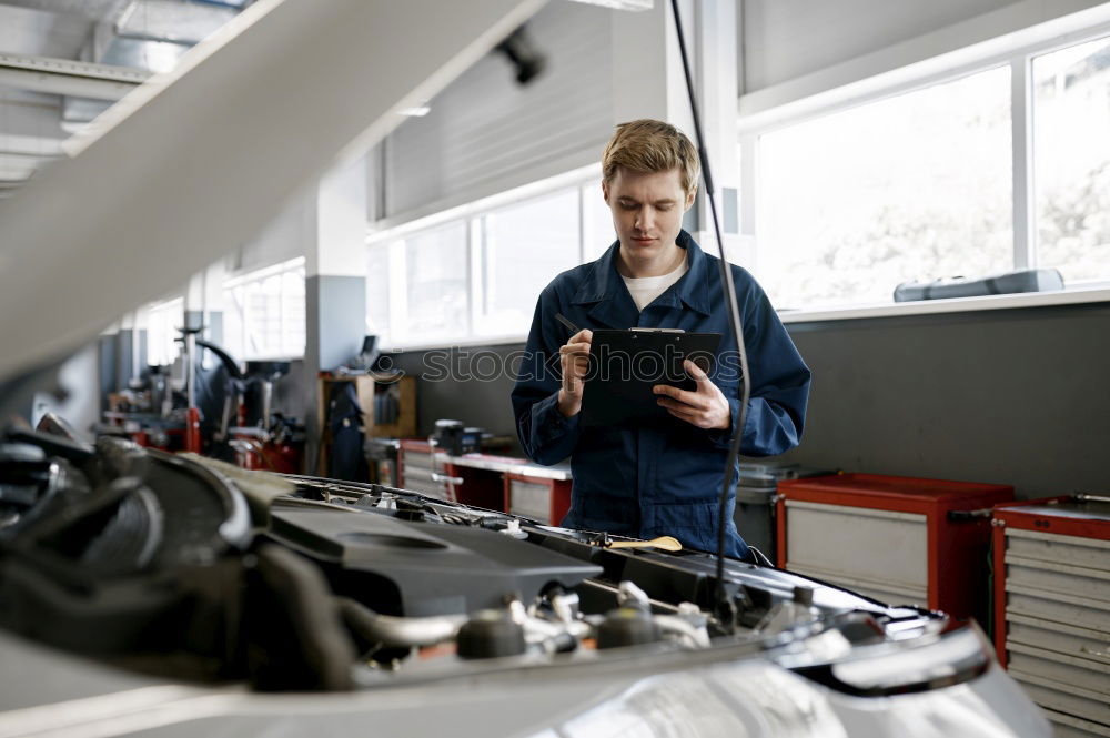 Image, Stock Photo Professional Mechanic Repairing Car.