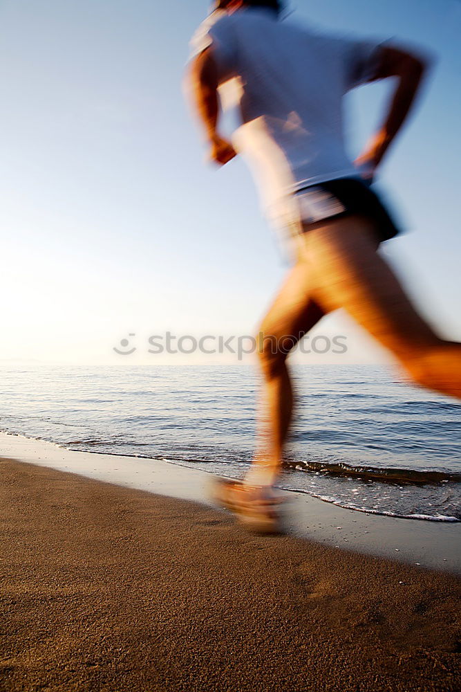 Similar – Man running at sunset on a sandy beach in a sunny day