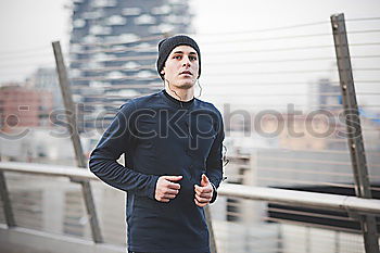 Similar – Image, Stock Photo Young man in sportswear leaning on metal fence and posing on sta