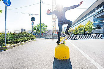 Similar – Woman jumping barefoot over blue rubber hills