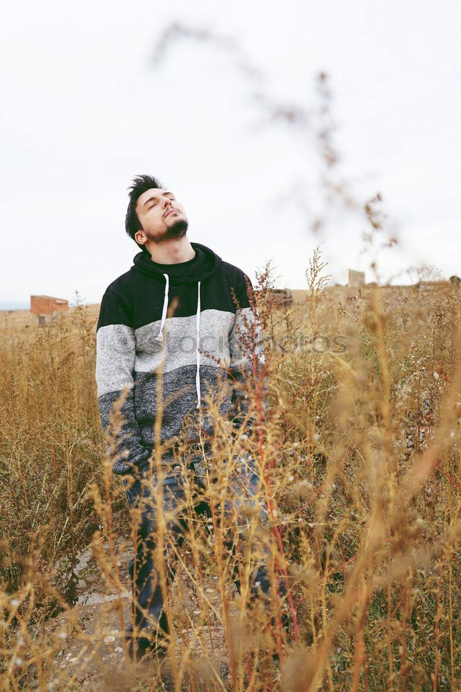 Similar – Bearded man sitting on dumpster