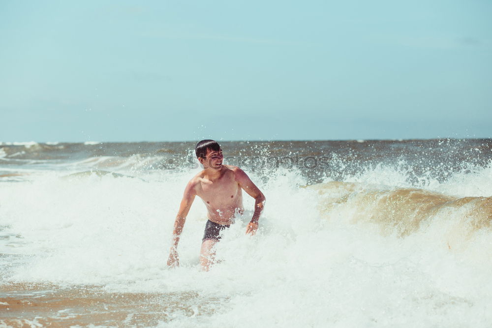 Similar – Young man enjoying the high waves in the sea