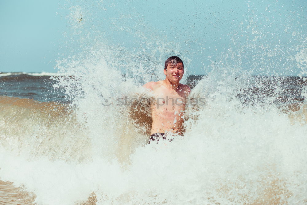 Similar – Young man enjoying the high waves in the sea