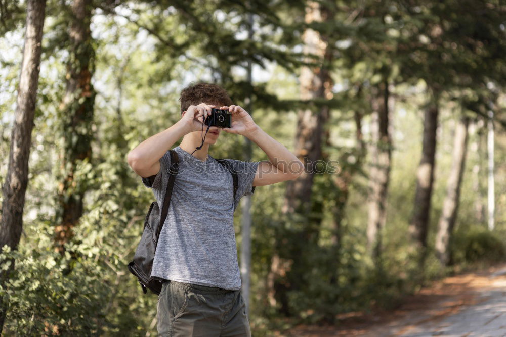 Similar – Full body image in the ground glass of an analog medium format camera of a tall beautiful woman with long dark curly hair in nature sitting barefoot under a tree