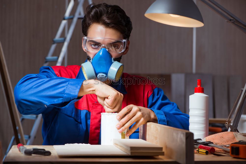 Similar – Image, Stock Photo Woman in protective clothes showing a blue paint roller