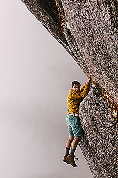 Similar – Rock climber clinging to a cliff.