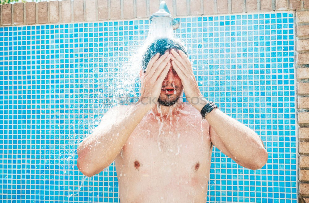 Similar – Young bearded man washing his hair