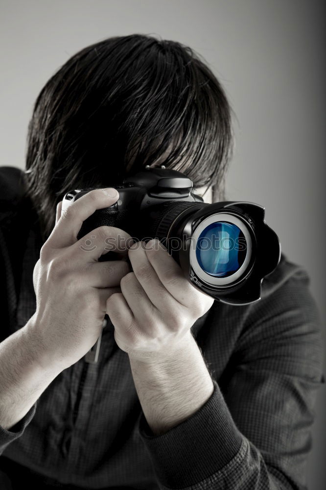 Similar – Bearded man dressed in blue t-shirt with binoculars posing against black background