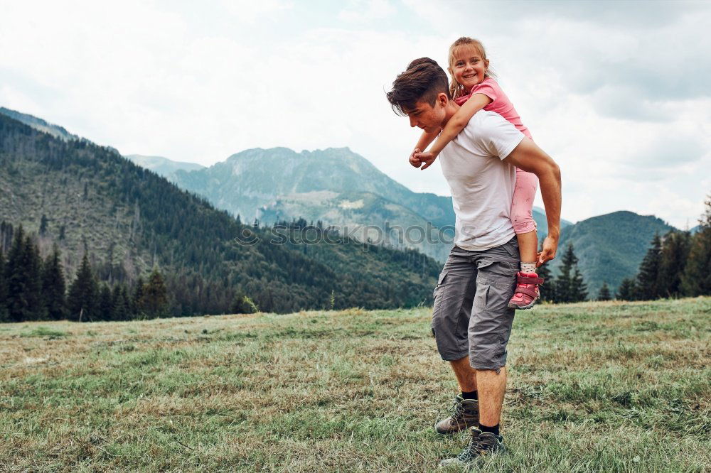 Similar – Image, Stock Photo Father and daughter standing near the lake at the day time.