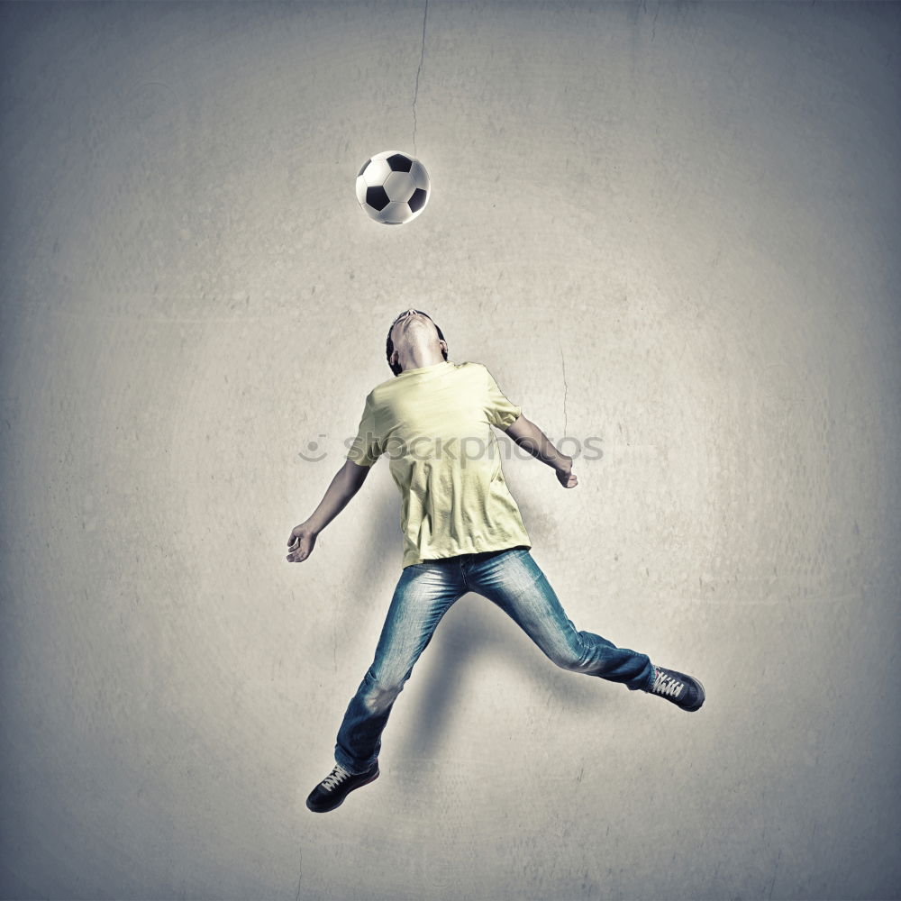 Young little boy playing in the field with soccer ball. Concept of sport.