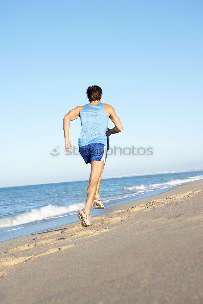 Similar – Man running at sunset on a sandy beach in a sunny day