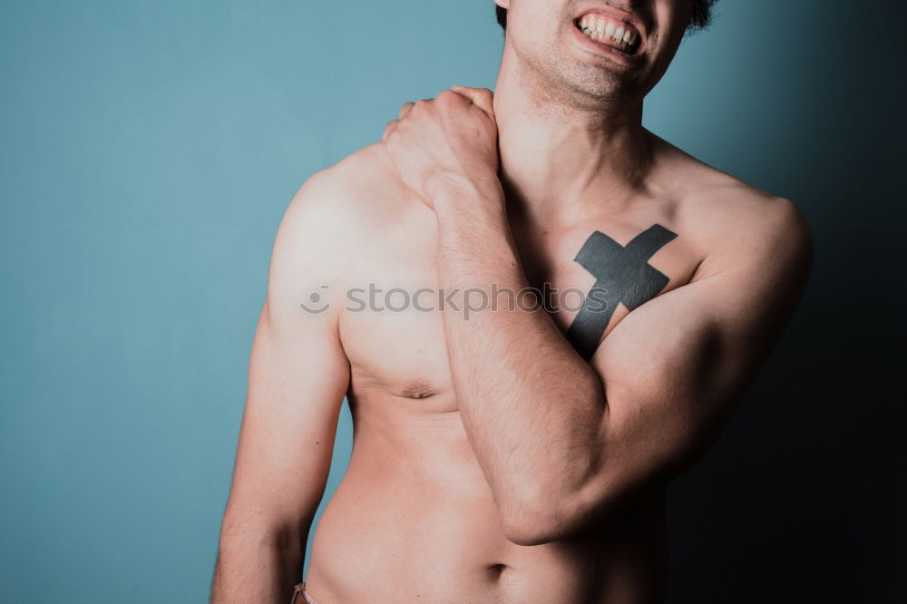 Similar – Image, Stock Photo young man spreads his arms like an angel while leaning against the wall with a tattoo on his bare chest